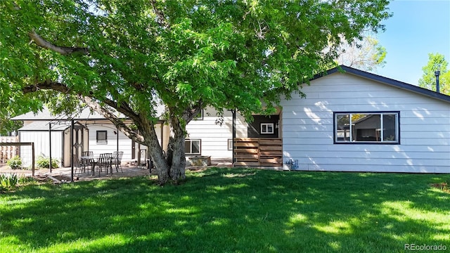 321 Stockton Ct, Gilcrest, CO 80623 - rear view of property featuring a lawn, a patio, a storage unit, and an outdoor structure