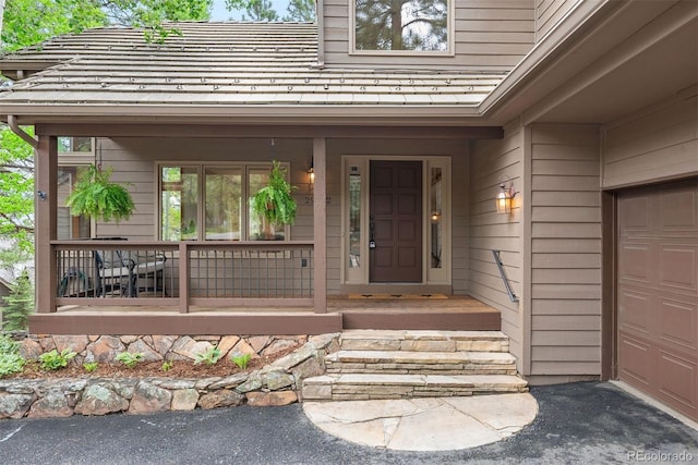 29962 Troutdale Ridge Rd, Evergreen, CO 80439 - entrance to property with covered porch and a garage