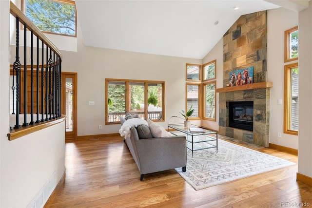 29962 Troutdale Ridge Rd, Evergreen, CO 80439 - living area with high vaulted ceiling, wood finished floors, baseboards, and stairs