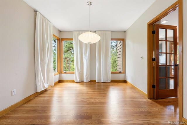 29962 Troutdale Ridge Rd, Evergreen, CO 80439 - unfurnished dining area featuring baseboards and wood finished floors