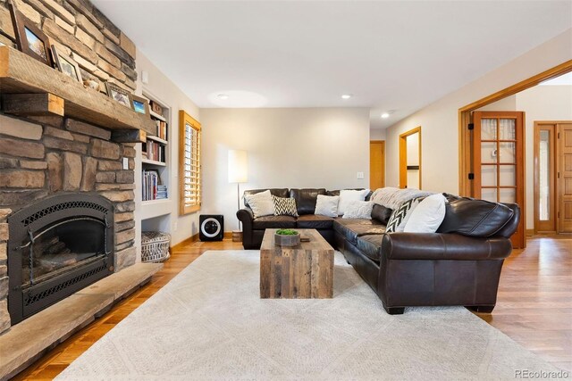 29962 Troutdale Ridge Rd, Evergreen, CO 80439 - living area with built in shelves, recessed lighting, wood finished floors, a fireplace, and baseboards