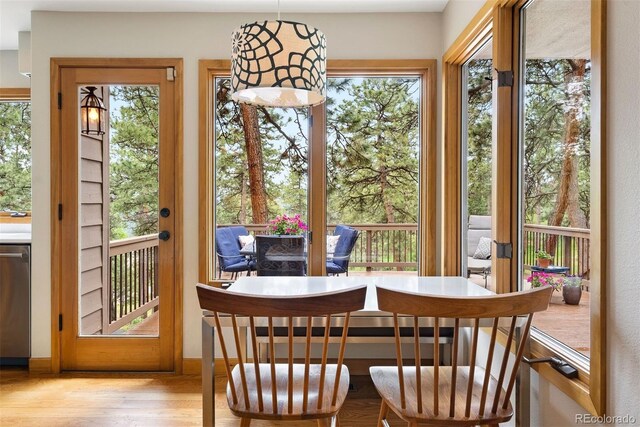 29962 Troutdale Ridge Rd, Evergreen, CO 80439 - dining space with plenty of natural light, wood finished floors, and baseboards