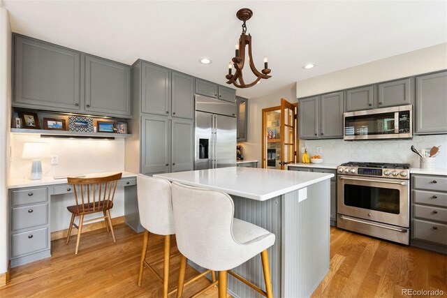 29962 Troutdale Ridge Rd, Evergreen, CO 80439 - kitchen with stainless steel appliances, gray cabinetry, light wood-type flooring, light countertops, and recessed lighting