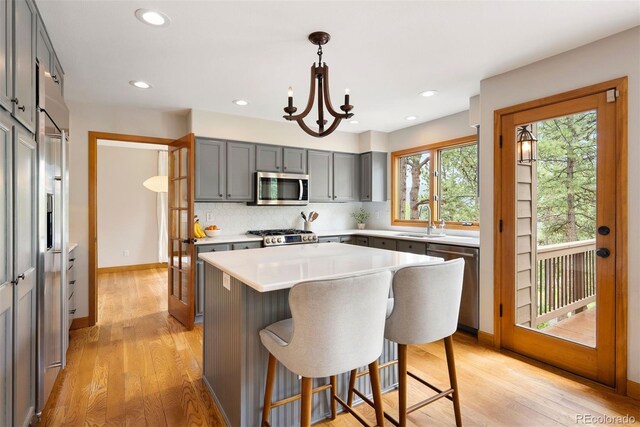 29962 Troutdale Ridge Rd, Evergreen, CO 80439 - kitchen with appliances with stainless steel finishes, gray cabinets, a sink, light wood-style floors, and recessed lighting