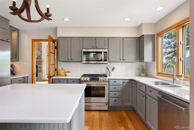 29962 Troutdale Ridge Rd, Evergreen, CO 80439 - kitchen with appliances with stainless steel finishes, gray cabinetry, a sink, and recessed lighting