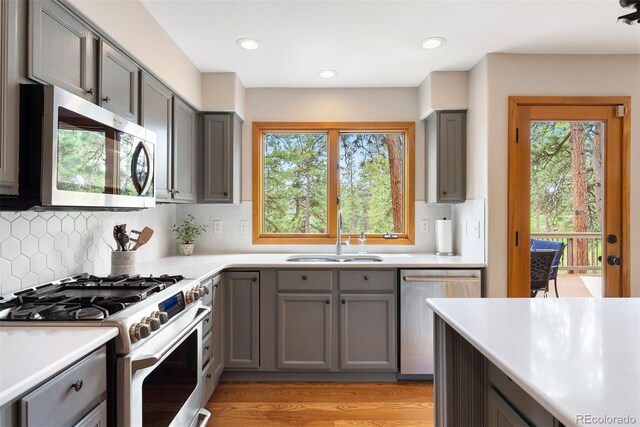 29962 Troutdale Ridge Rd, Evergreen, CO 80439 - kitchen with stainless steel appliances, gray cabinetry, a sink, light countertops, and recessed lighting