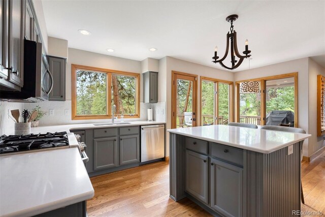 29962 Troutdale Ridge Rd, Evergreen, CO 80439 - kitchen featuring stainless steel appliances, gray cabinets, a sink, healthy amount of natural light, and recessed lighting