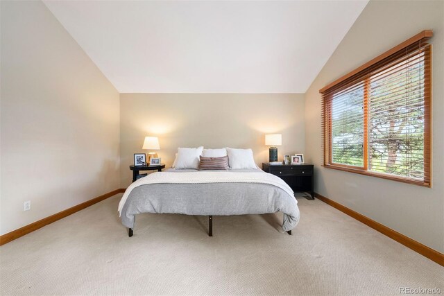 29962 Troutdale Ridge Rd, Evergreen, CO 80439 - bedroom with vaulted ceiling, baseboards, and light colored carpet