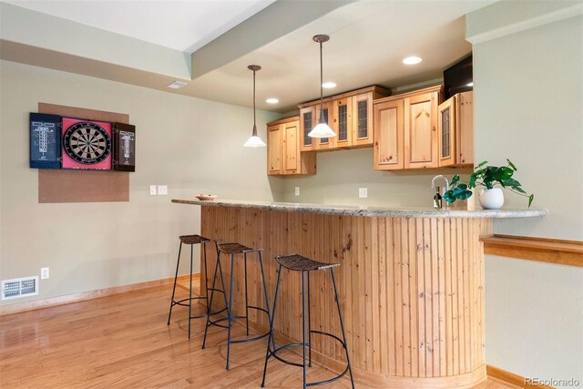 29962 Troutdale Ridge Rd, Evergreen, CO 80439 - kitchen featuring a breakfast bar, a peninsula, light brown cabinetry, glass insert cabinets, and recessed lighting