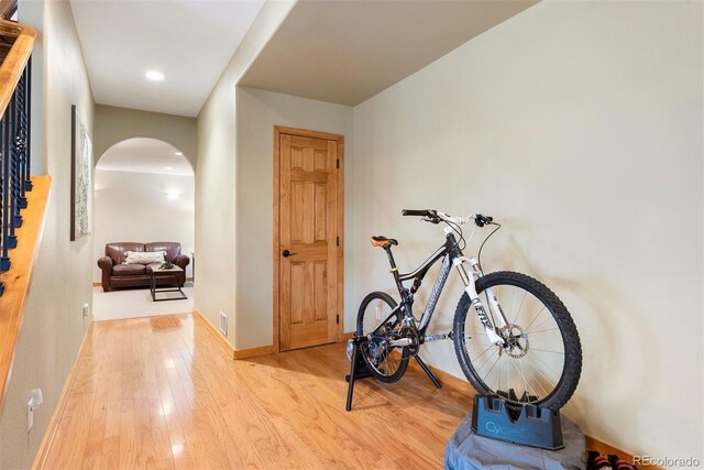 29962 Troutdale Ridge Rd, Evergreen, CO 80439 - corridor featuring arched walkways, wood finished floors, and baseboards
