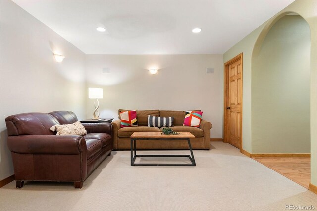 29962 Troutdale Ridge Rd, Evergreen, CO 80439 - living room with arched walkways, recessed lighting, light carpet, and baseboards