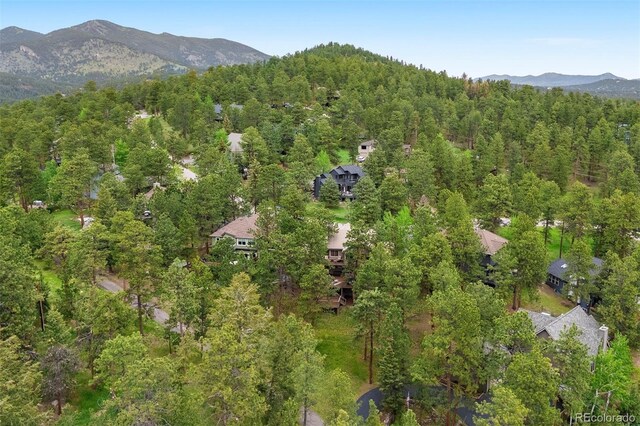 29962 Troutdale Ridge Rd, Evergreen, CO 80439 - aerial view of property and surrounding area featuring a heavily wooded area and a mountainous background