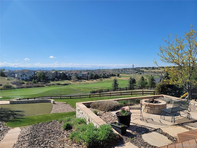 exterior space featuring an outdoor fire pit, a mountain view, and a patio