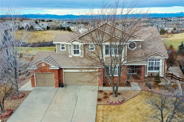 view of front of property with a garage and a mountain view