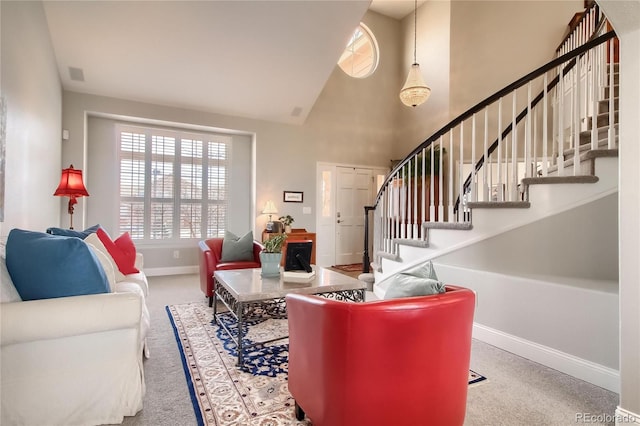 carpeted living room with a towering ceiling