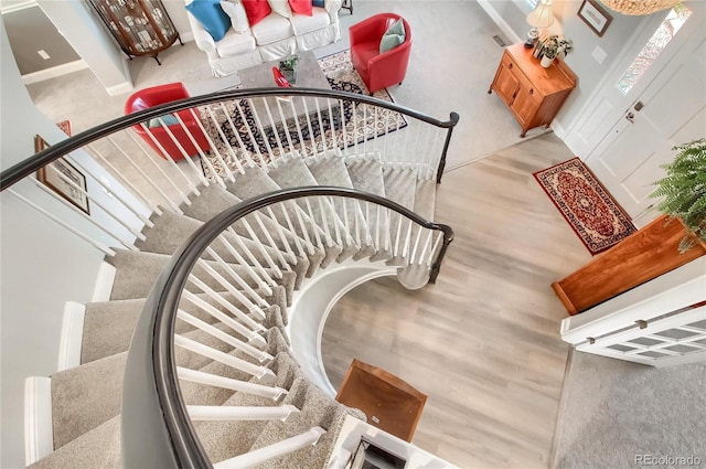 stairs featuring hardwood / wood-style floors