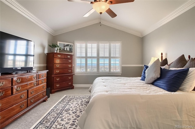 carpeted bedroom with ornamental molding, lofted ceiling, and ceiling fan