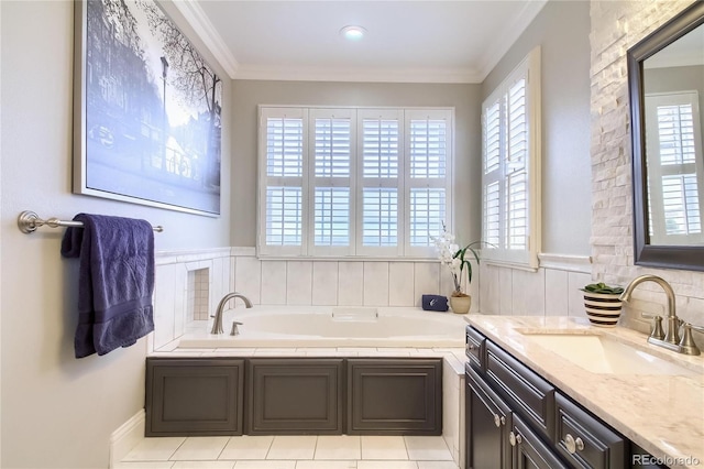 bathroom with a washtub, vanity, crown molding, and tile patterned floors