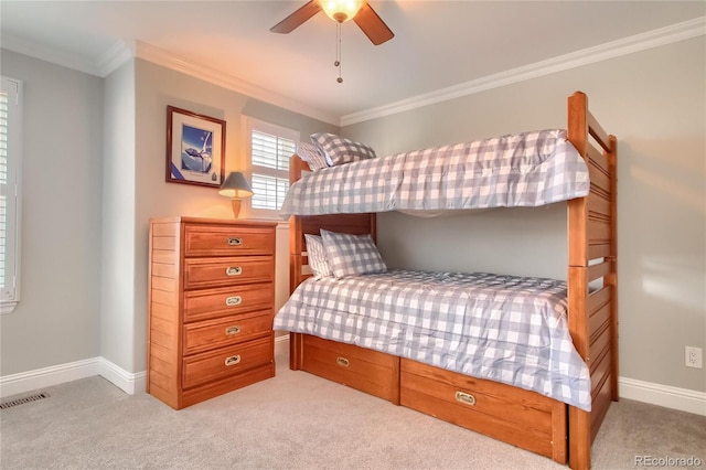 bedroom featuring ceiling fan, light colored carpet, and ornamental molding