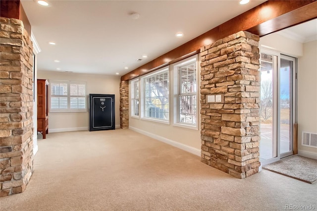 unfurnished living room featuring light colored carpet