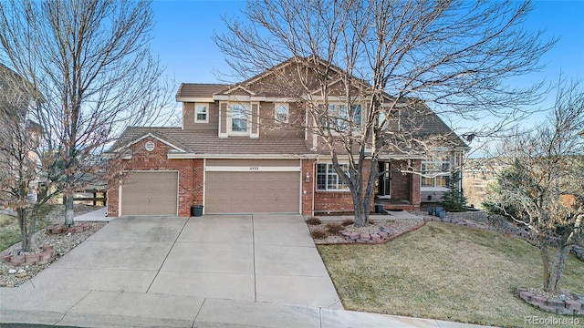 view of front of home with a garage and a front lawn