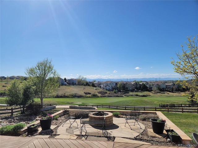 deck with an outdoor fire pit and a lawn