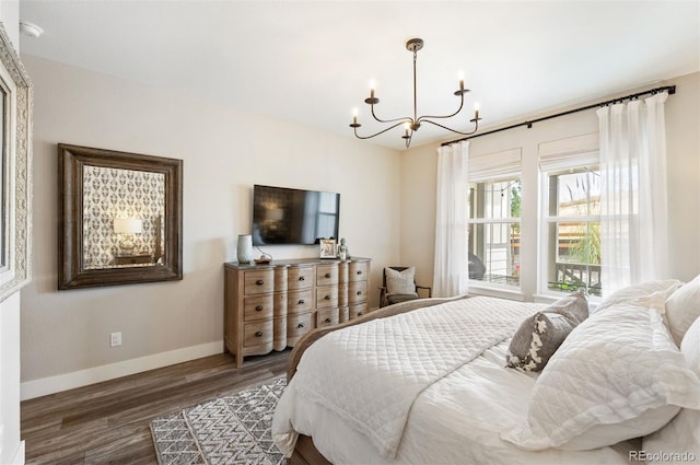 bedroom featuring a chandelier and dark hardwood / wood-style flooring