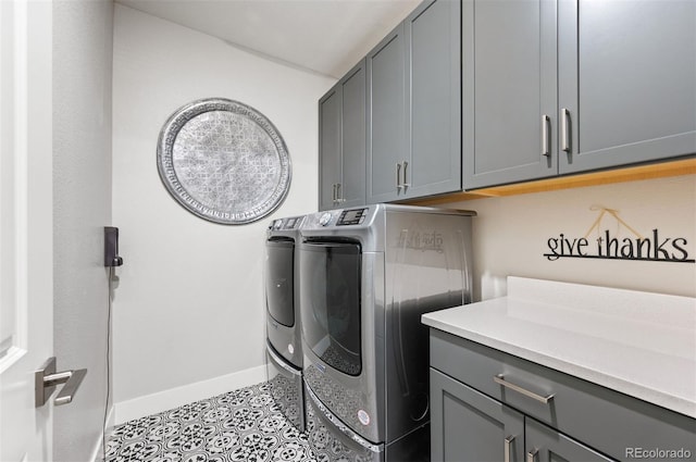 laundry area with cabinets, light tile patterned flooring, and independent washer and dryer