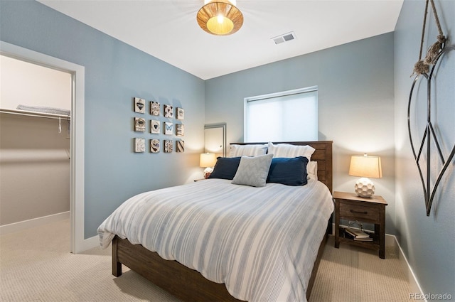 carpeted bedroom featuring a closet and a spacious closet