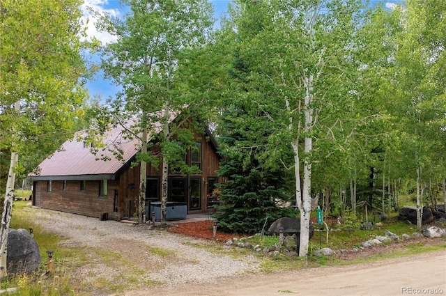 view of front of house featuring metal roof and driveway