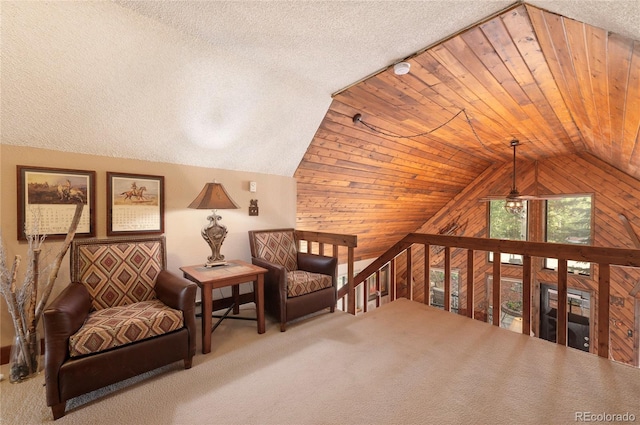 living area with carpet, ceiling fan, a textured ceiling, and lofted ceiling