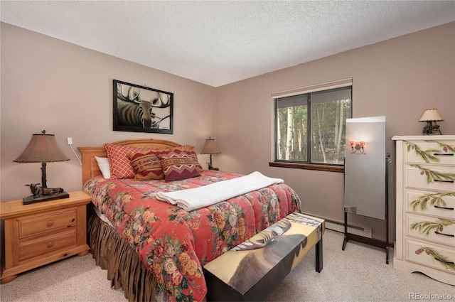 bedroom featuring light carpet and a textured ceiling