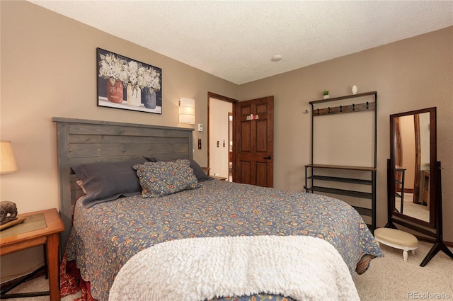 bedroom featuring a textured ceiling and carpet floors
