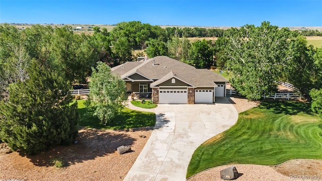 view of front of house featuring a garage and a front lawn