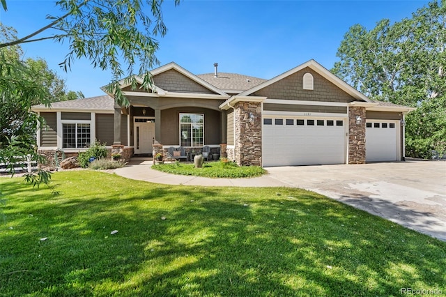 craftsman-style house with a garage, a front yard, and covered porch