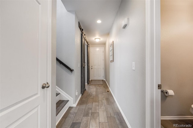 corridor with hardwood / wood-style flooring