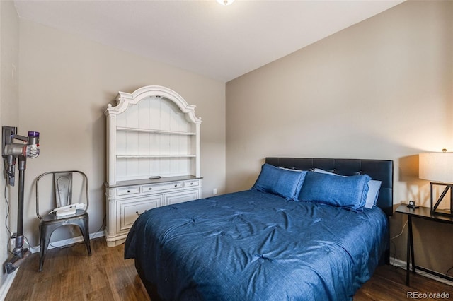 bedroom with dark wood-type flooring