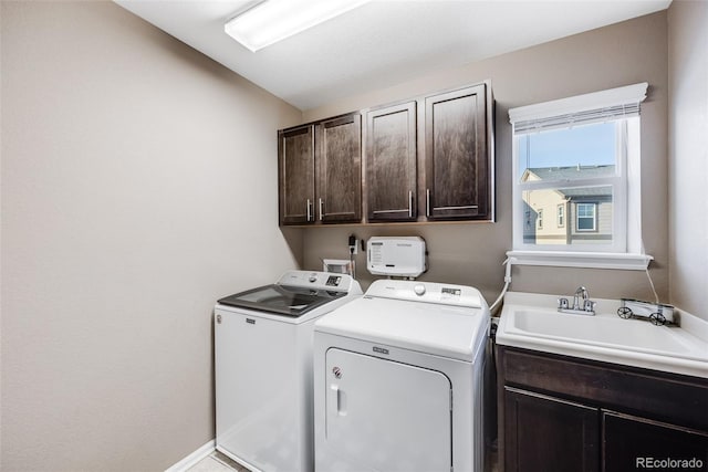 laundry room with sink, separate washer and dryer, and cabinets