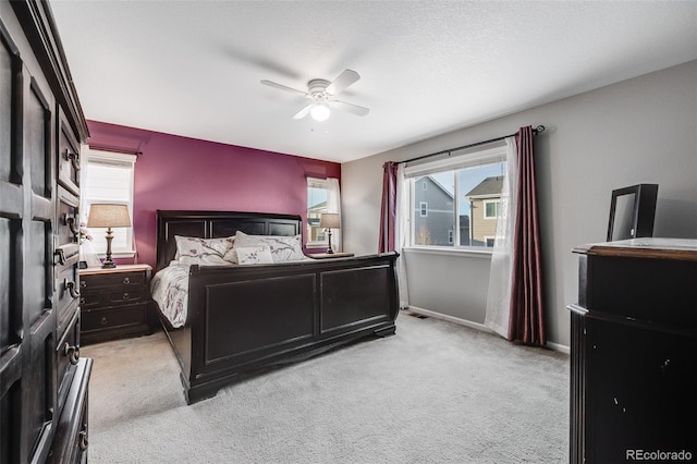 bedroom featuring ceiling fan and light carpet