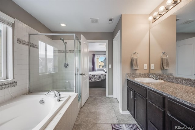 bathroom featuring vanity, tile patterned flooring, and separate shower and tub