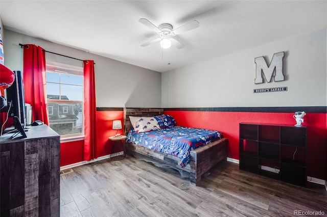 bedroom with hardwood / wood-style floors and ceiling fan