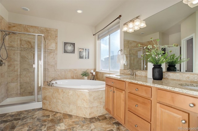 bathroom with vanity and independent shower and bath