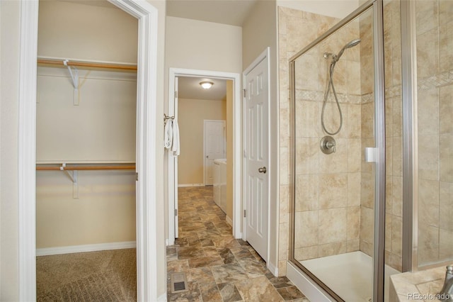 bathroom with a shower with door