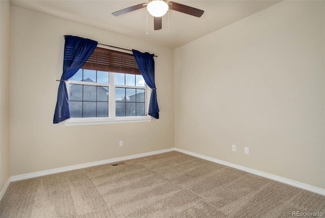 carpeted empty room featuring ceiling fan