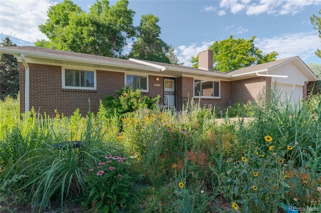 2976 S Magnolia Way, Denver, CO 80224 - single story home with brick siding, a garage, and a chimney