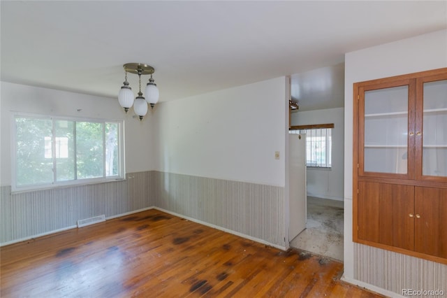 2976 S Magnolia Way, Denver, CO 80224 - unfurnished room with wood finished floors and a wainscoted wall