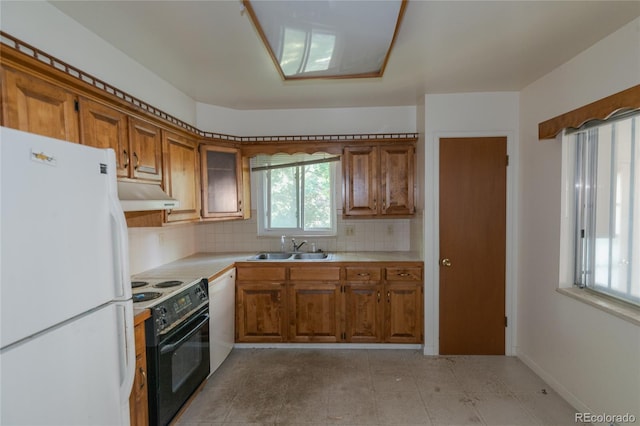 2976 S Magnolia Way, Denver, CO 80224 - kitchen with white appliances, under cabinet range hood, and brown cabinetry