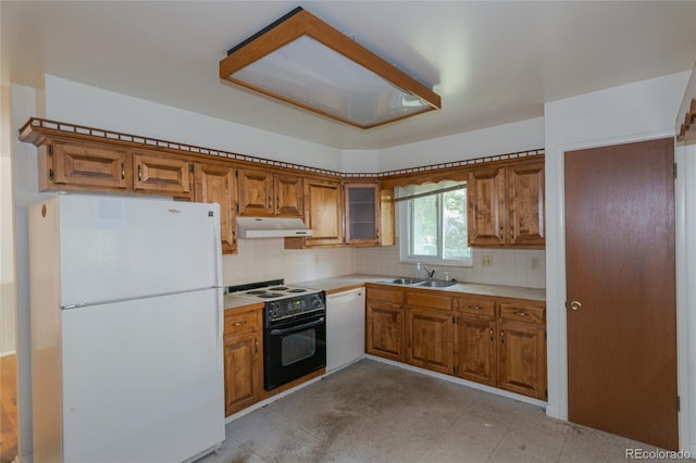 2976 S Magnolia Way, Denver, CO 80224 - kitchen with white appliances, brown cabinetry, under cabinet range hood, and light countertops