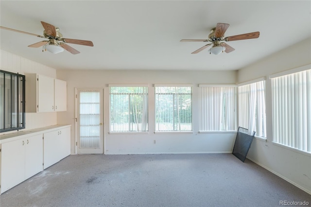 2976 S Magnolia Way, Denver, CO 80224 - unfurnished sunroom with baseboards