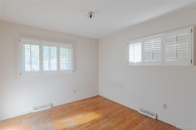2976 S Magnolia Way, Denver, CO 80224 - empty room featuring healthy amount of natural light and light wood-style floors